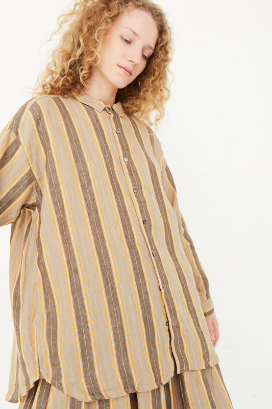 The model is wearing a relaxed fit Linen Stripe Shirt in Mustard by Ichi Antiquités.