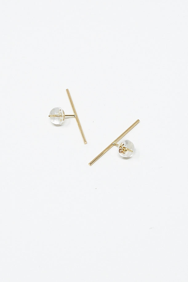 A pair of Kathleen Whitaker Stick Stud 1" Single Earrings in 14K Yellow Gold on a white surface.
