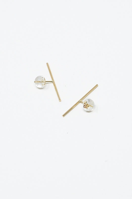 A pair of Kathleen Whitaker Stick Stud 1" Single Earrings in 14K Yellow Gold on a white surface.