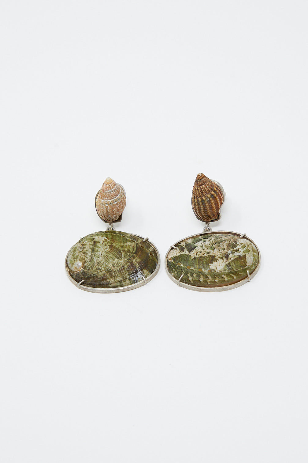 A pair of unique La Mar sterling silver shell earrings in green and brown, made with sterling silver, on a white surface.
