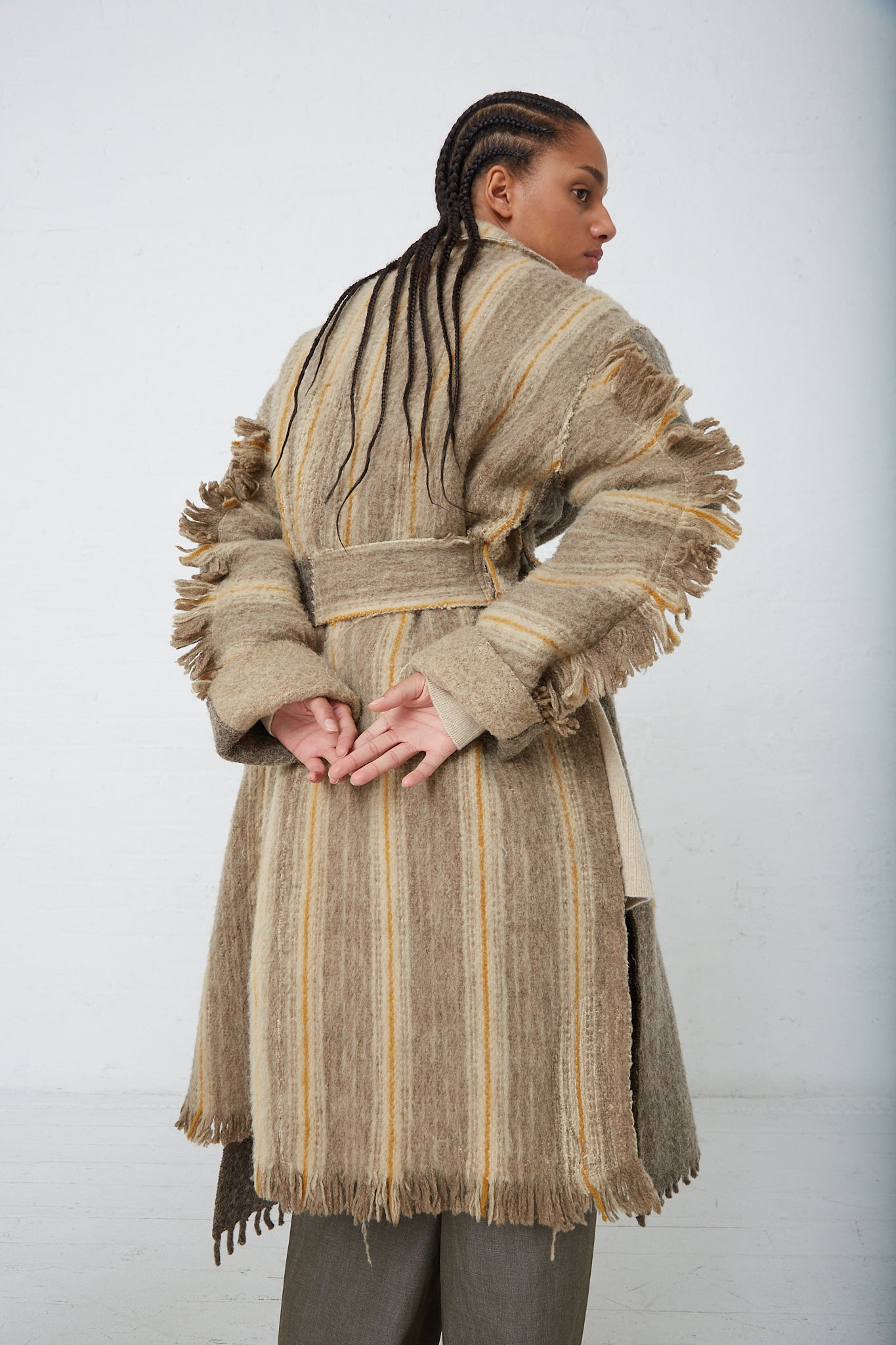 A woman wearing a Thank You Have A Good Day Wool Blanket Swing Trench trench coat. Back view.