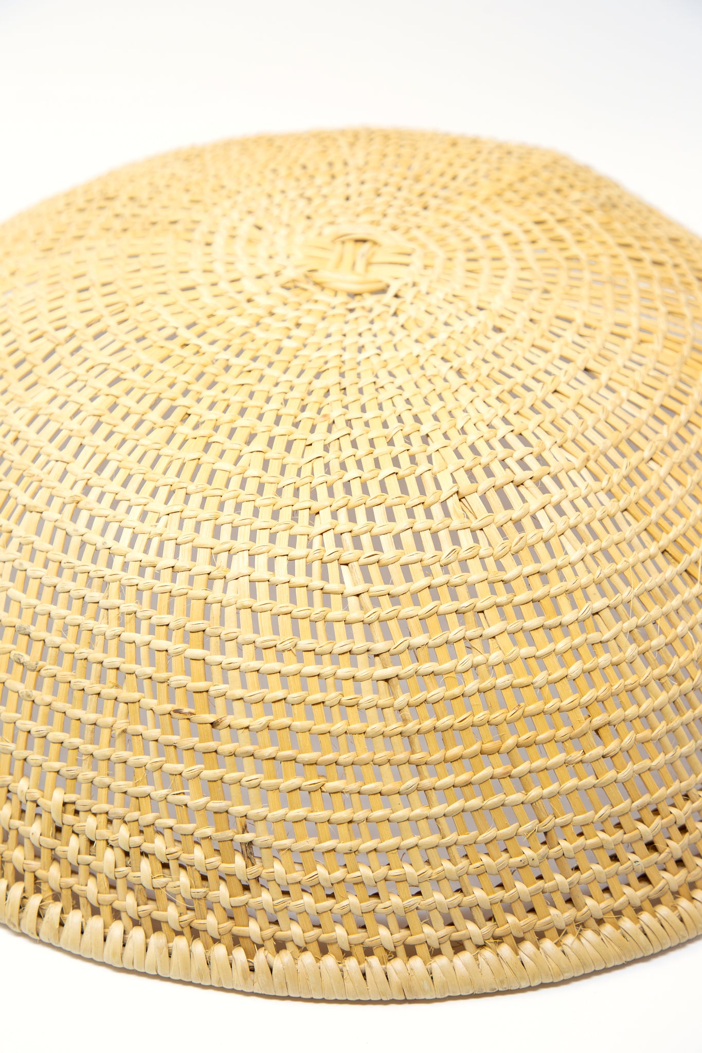 A Plaza Bolivar XL Avia Pova Basket, handmade with traditional basket weaving techniques by an artisan, placed on a white background. Up close to show basket texture.
