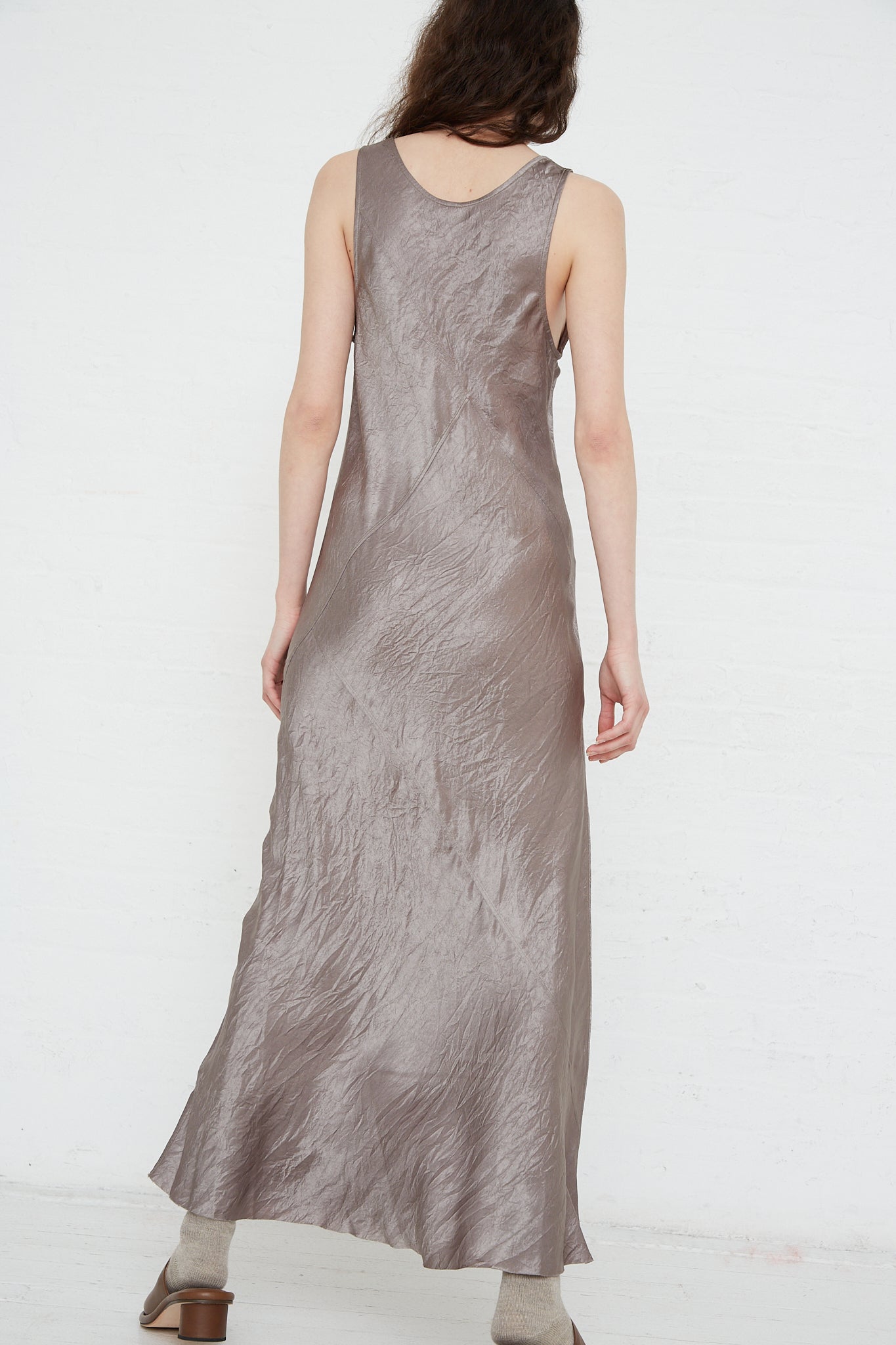 The back view of a woman wearing a Luster Bias Dress in Laurel by Lauren Manoogian.