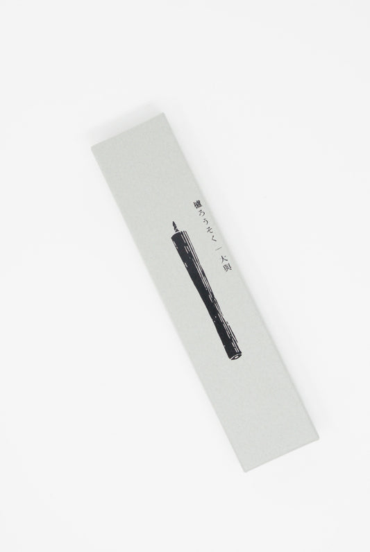 A black pencil coated with natural Daiyo Sumac Wax Candle White No.5 on a surface.