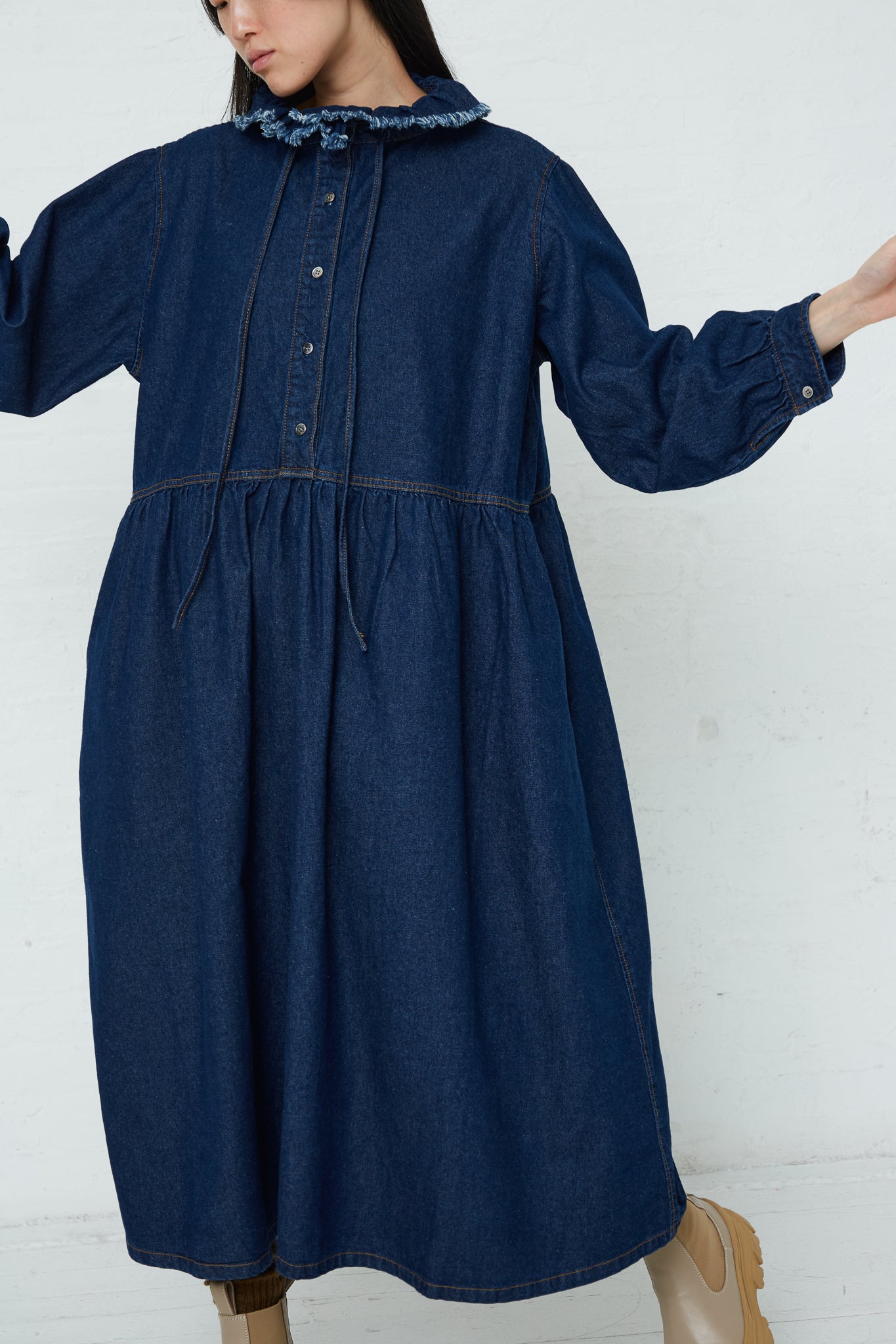 A woman wearing an Ichi Cotton Collar Dress in Dark Indigo with ruffled collar.
