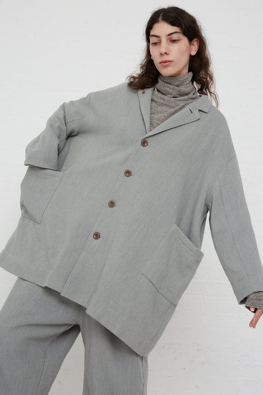 The model is wearing an oversized Ichi Antiquités Merino Wool Orihimedaki Jacket in Blue.