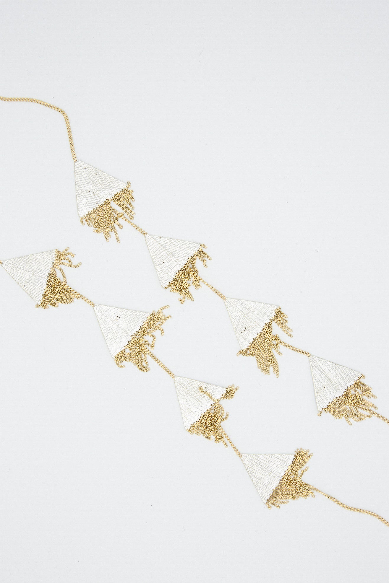A handmade Triangle Necklace in Brass Chain and Silver Solder by Hannah Keefe, with tassels and featuring silver soldered brass elements and geometric forms.