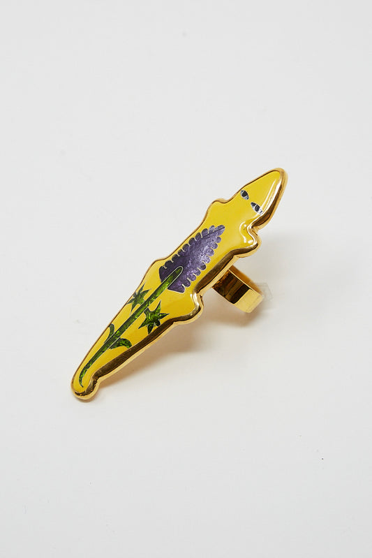 An enamel ring with a cloisonné flower would be replaced with "A Ring in Yellow Alligator with Flower from Sofio Gongli".