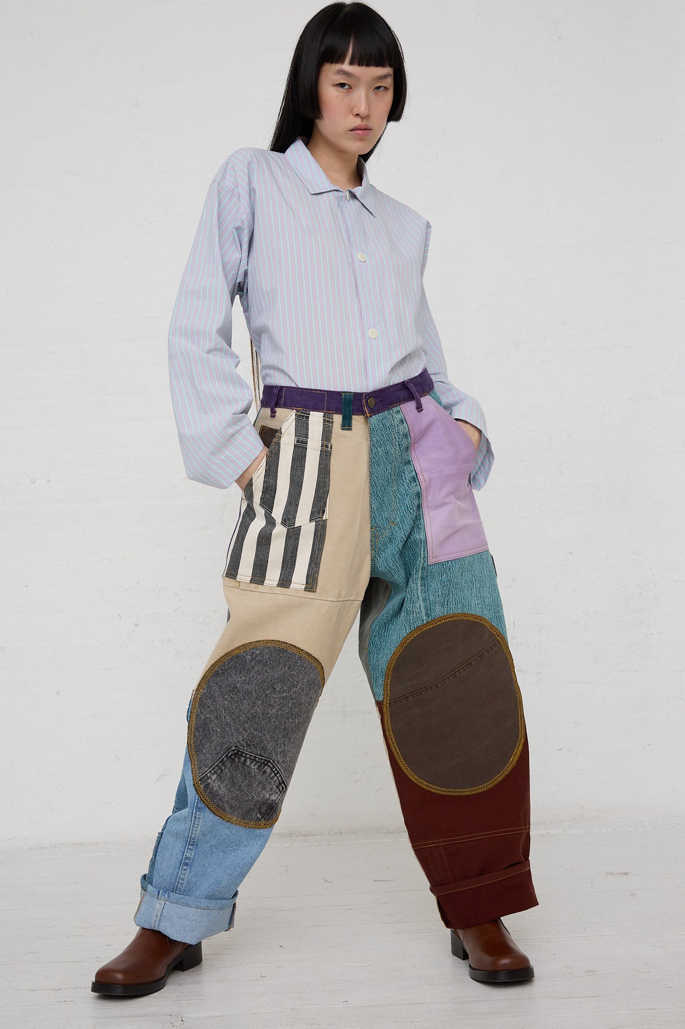 A woman wearing WildRootz handmade Reworked Jeans in Multicolor II and a striped shirt.